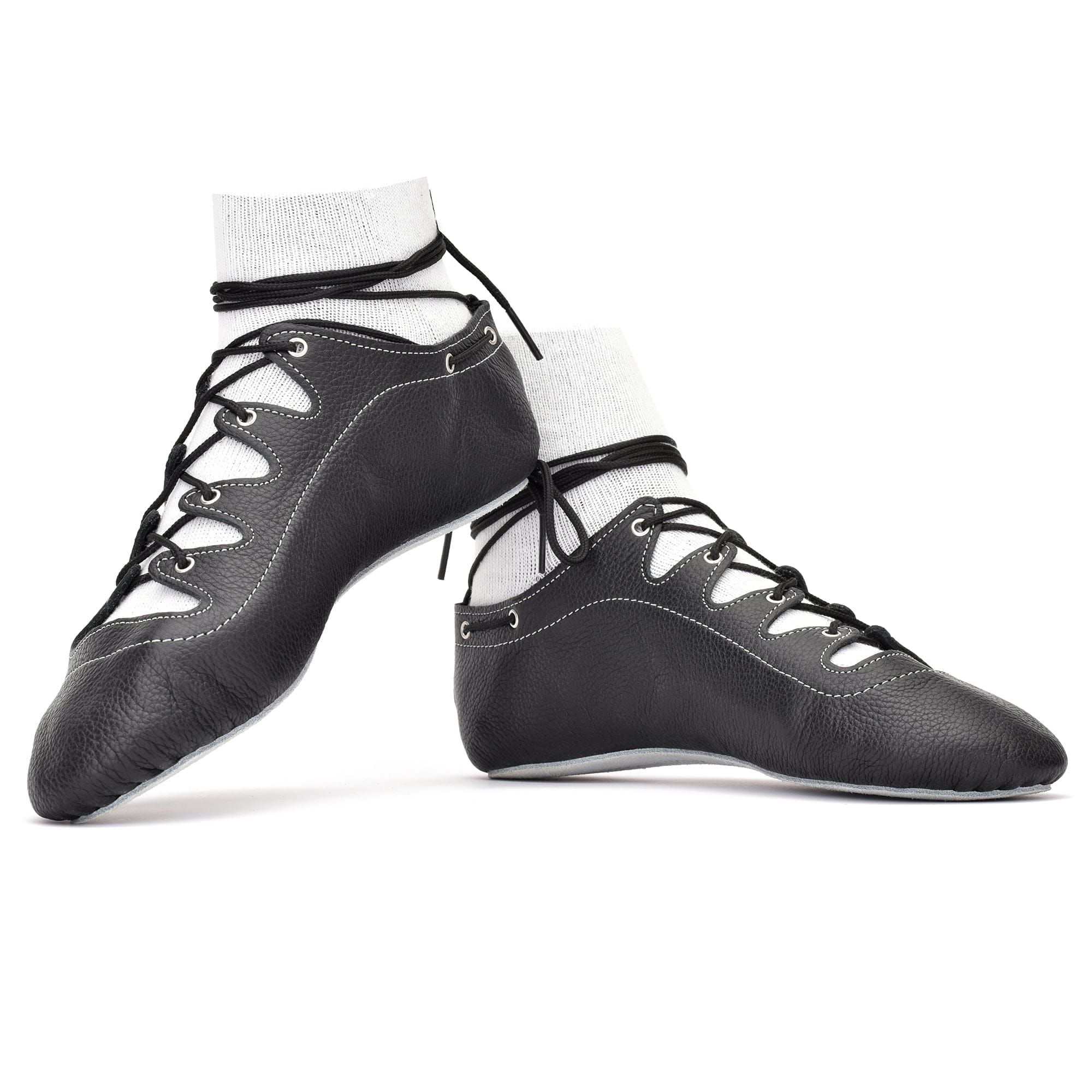 Black leather highland dance pumps with cross-lace eyelets, straight-lasted sole and shock-absorbing insole — handcrafted in Scotland for precise performance.