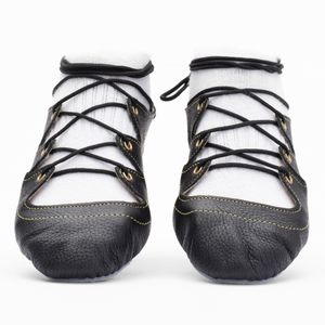 Black leather Highland dance pumps with 4-finger lace system, front seam and loop, extra ankle eyelet, and flexible chrome suede sole.