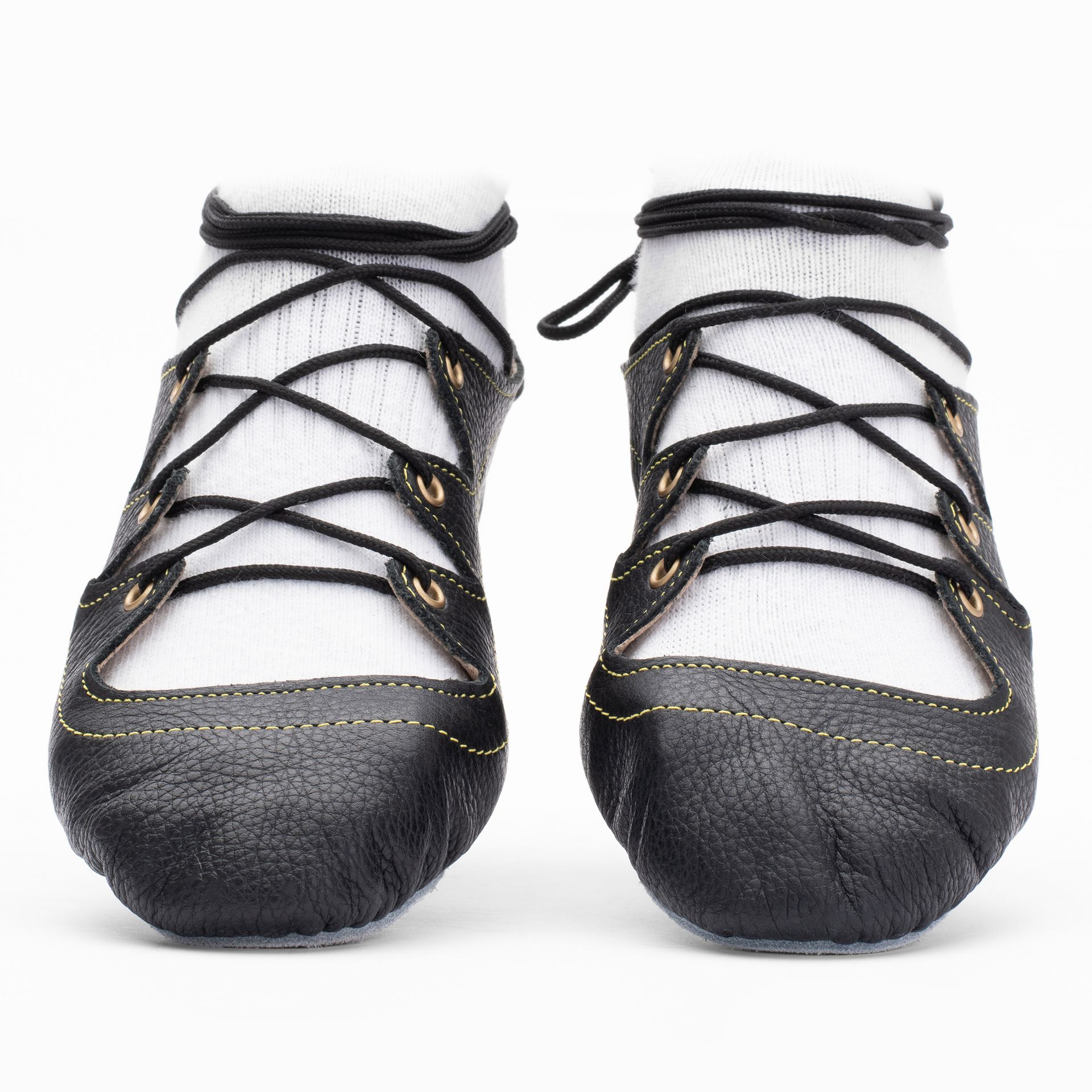 Black leather Highland dance pumps with 4-finger lace system, front seam and loop, extra ankle eyelet, and flexible chrome suede sole.