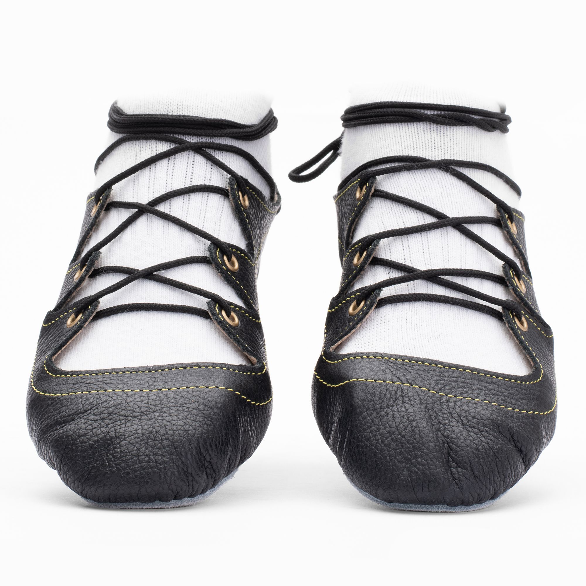 Black leather Highland dance pumps with 4-finger lace system, front seam and loop, extra ankle eyelet, and flexible chrome suede sole.